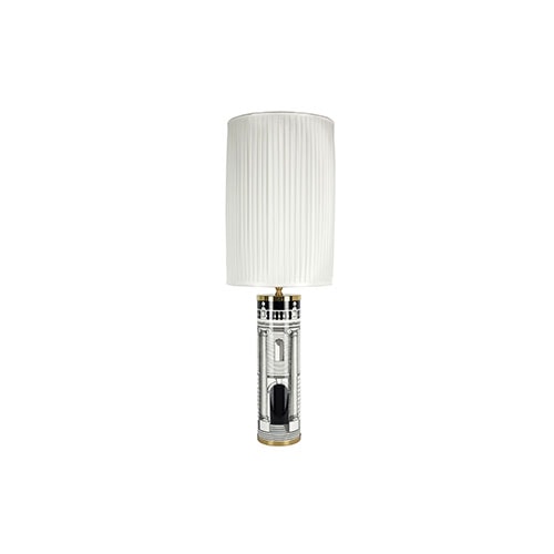 Casa con Colonne Cylindrical Lamp with white shade on top in front of a white background