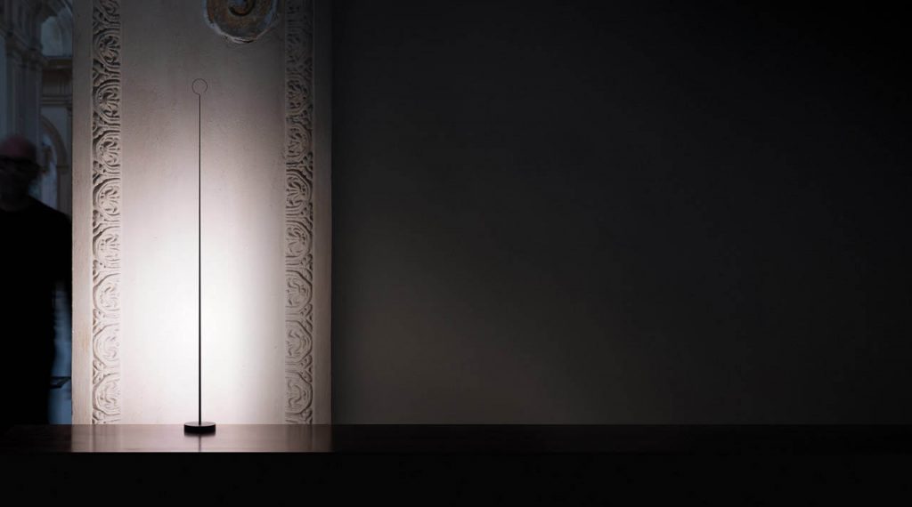 Anima light shining against a white wall in dark room