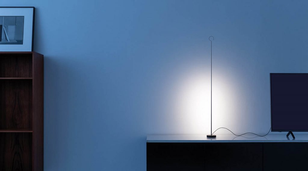 Anima light on top of a console shining against a white wall in a dawn time