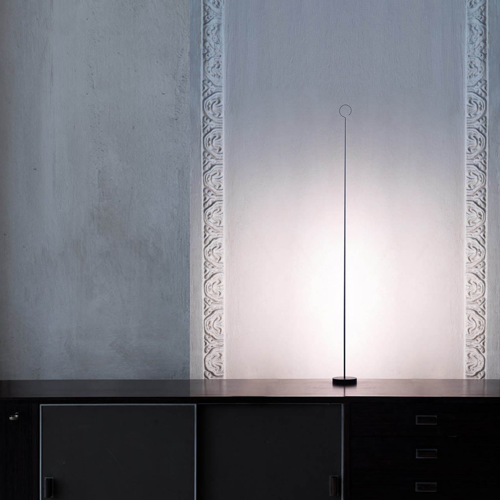 Anima lamp on a desk shining against a white wall