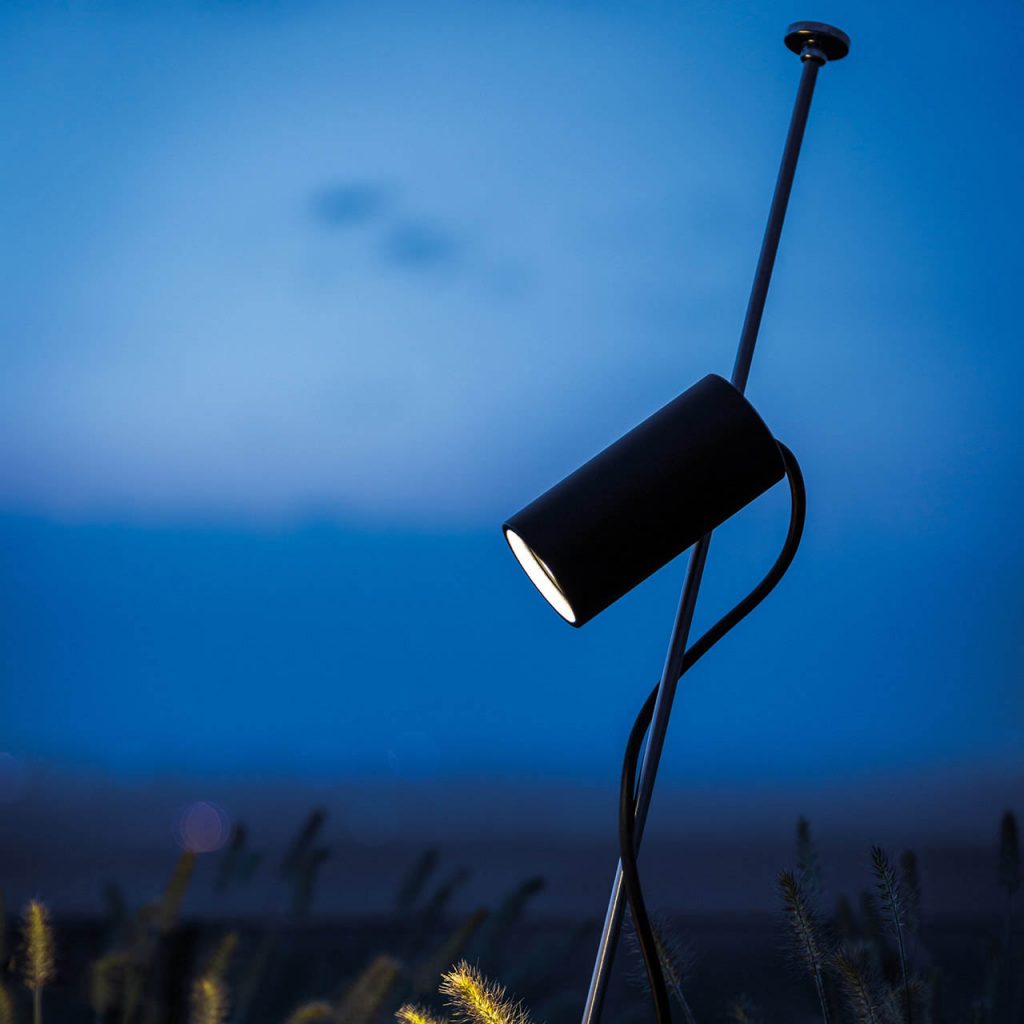 Grillo outdoor lamp in front of a dusk sky