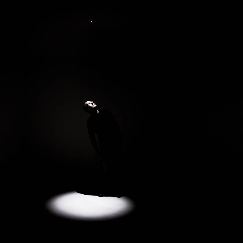 Nulla twenty five recessed lights illuminating a person in a dark room