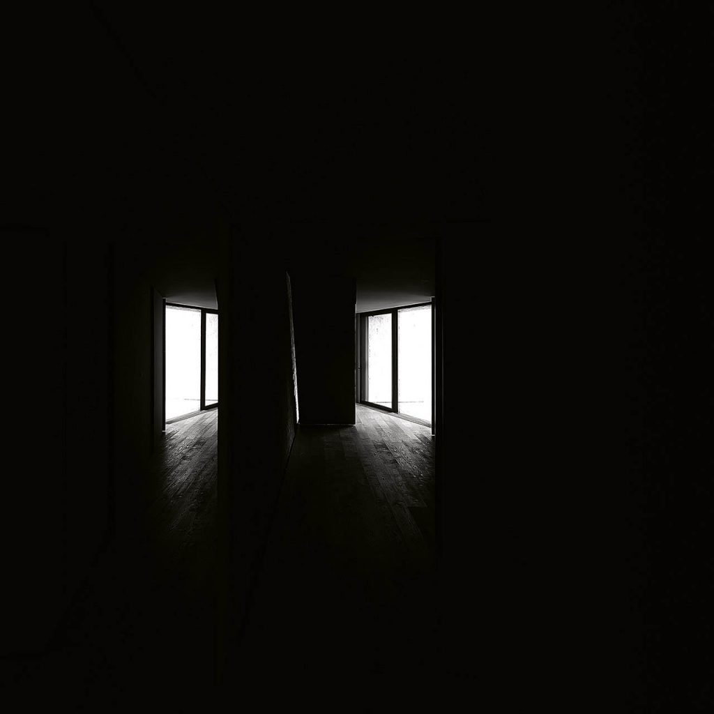 Dark room showing how the Nulla twenty five recessed lights are illuminating the two sections they are located
