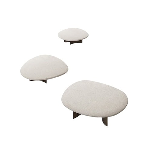 A set of sculptural low tables with soft rounded tops in a creamy finish and minimal curved bases, offering a natural and organic look.