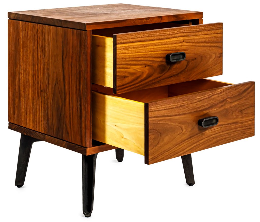 Mcqueen bedside table with drawers opened in front of a white background