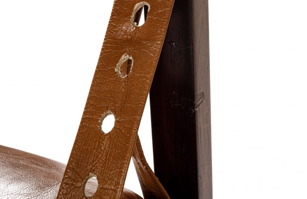 Close up of top straps of Sergio Rodrigues Tonico Three in front of a white background