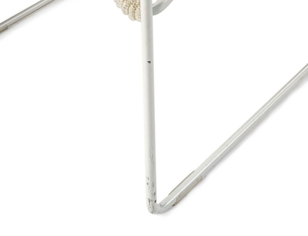 Close up of Twist low stool's angled leg in front of a white background