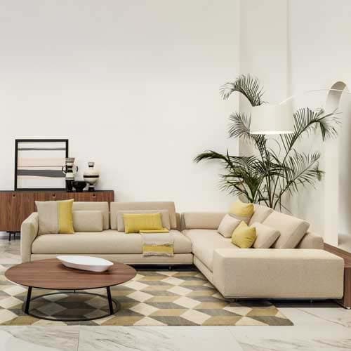 Cream colored Miles sofa on a cream colored rug with multicolored patterns