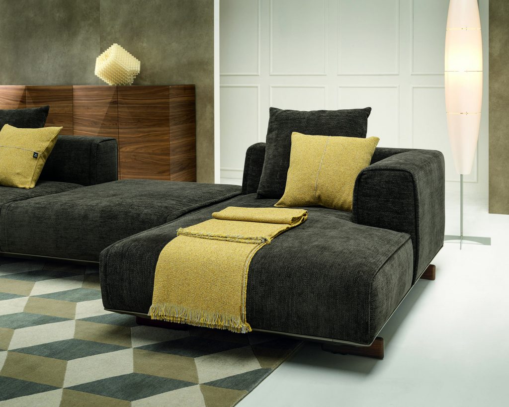 Close up on two toned Coleman sofa in black with thick yellow strip going through horizontally