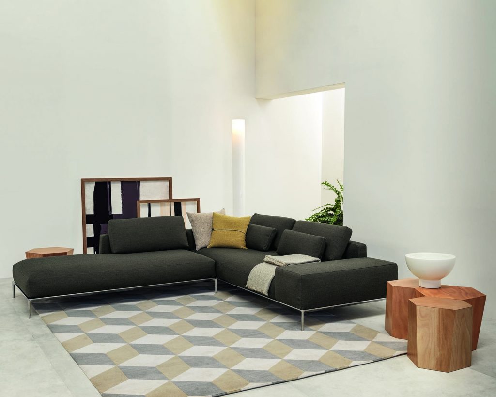 Hexagon in wood finish next to dark colored couch