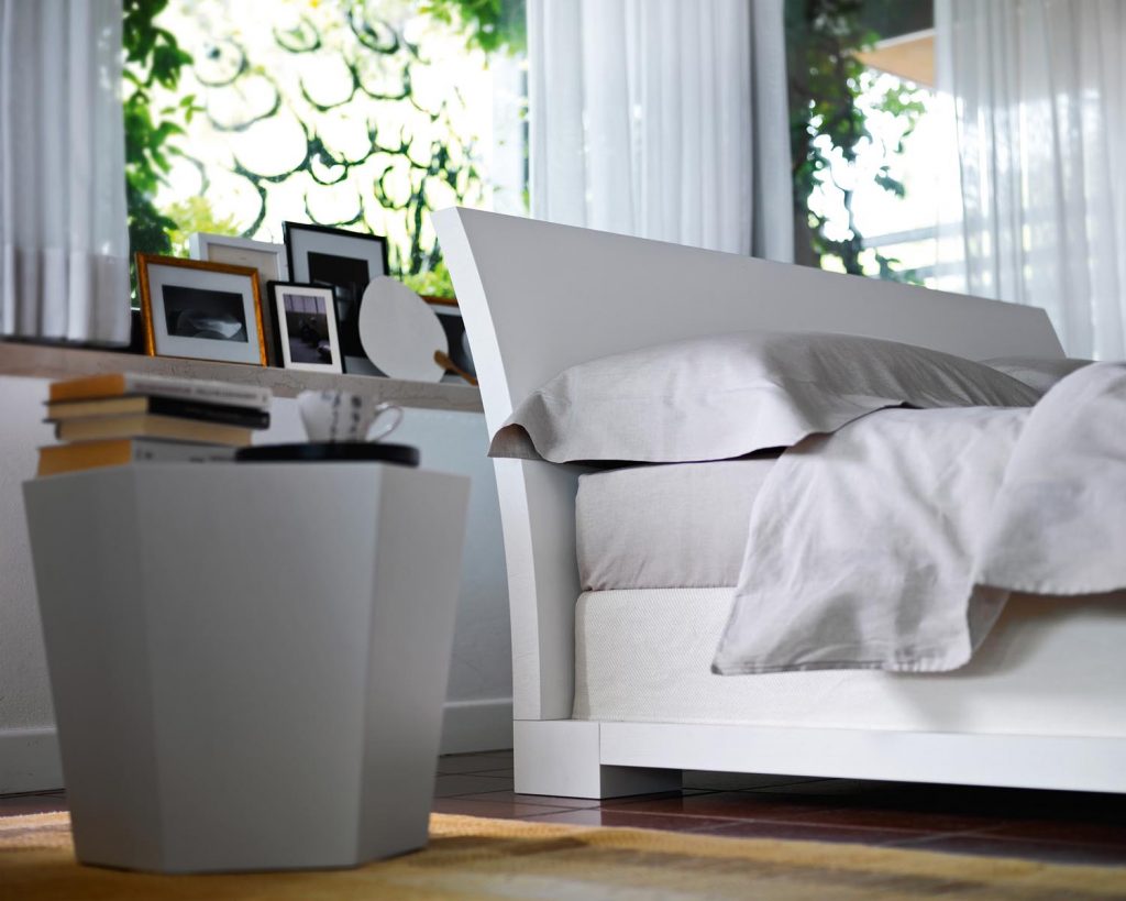 Hexagon in a grey color next to a bed