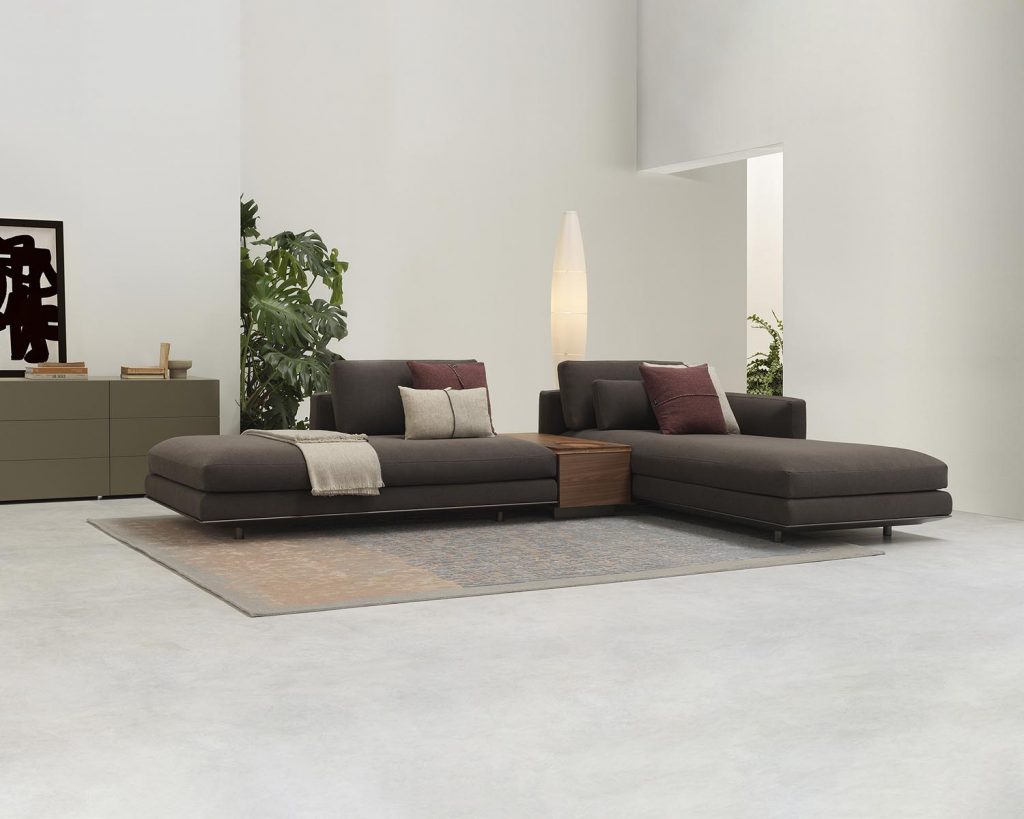 Brown colored Miles sofa surrounded by white walls and on top of a rug
