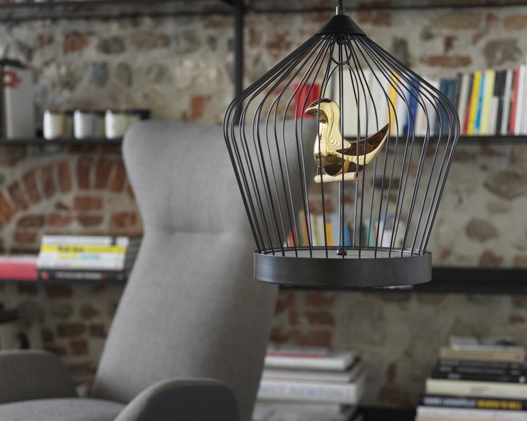Close up of grey Soho chair with a bird cage in front