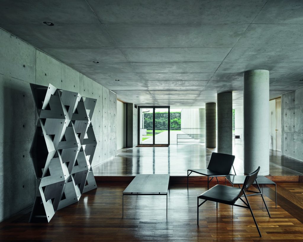 Torii in front of a seat in a large white room