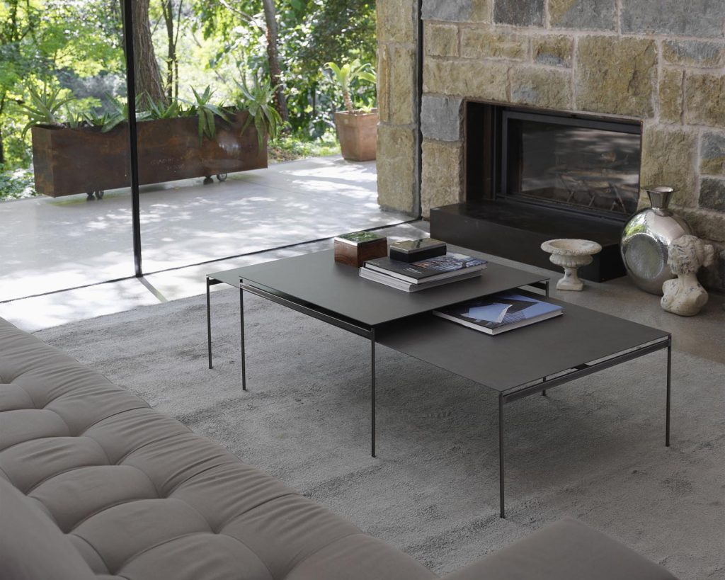 Torii in front of some windows with a grey couch next to it