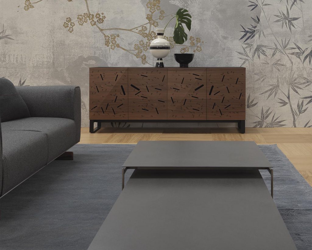 Torii in front of a cabinet and next to a dark grey couch