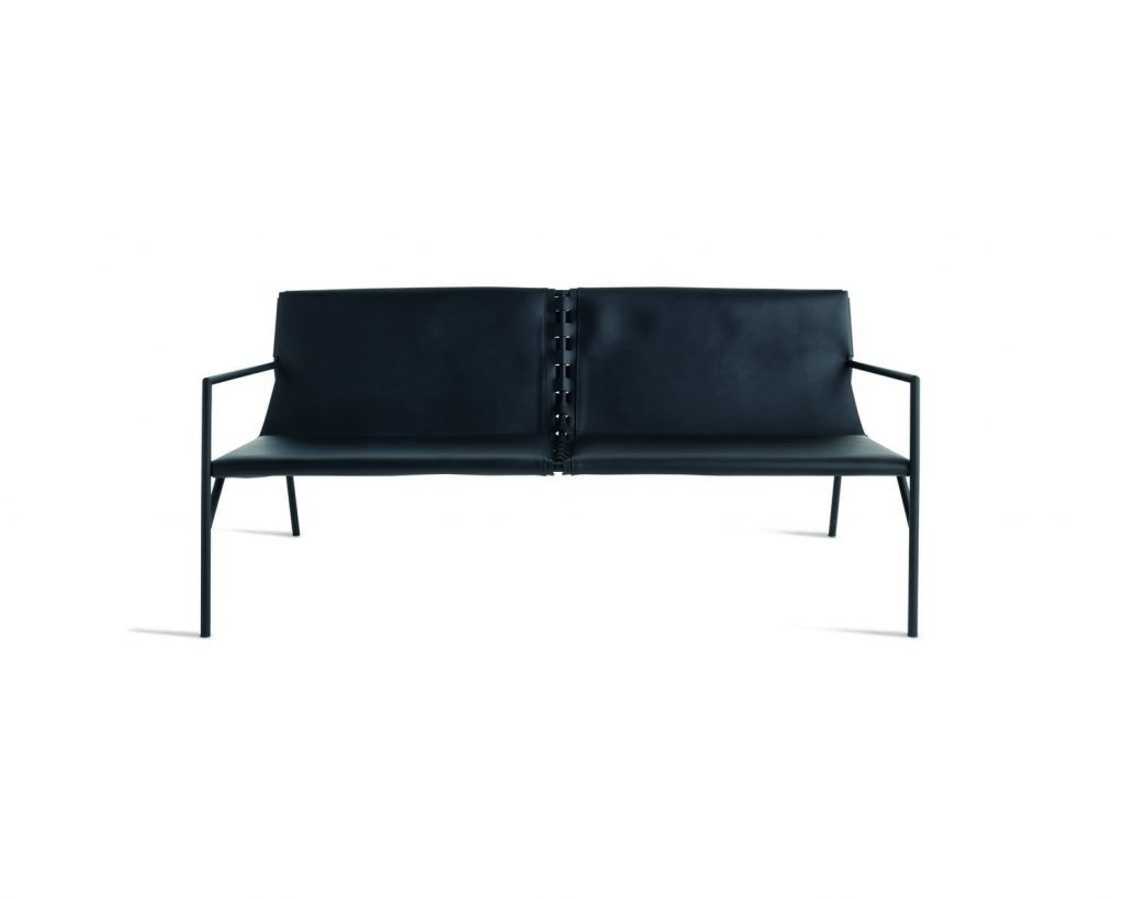 A front facing black colored Tout Le Jour sofa with a white background behind
