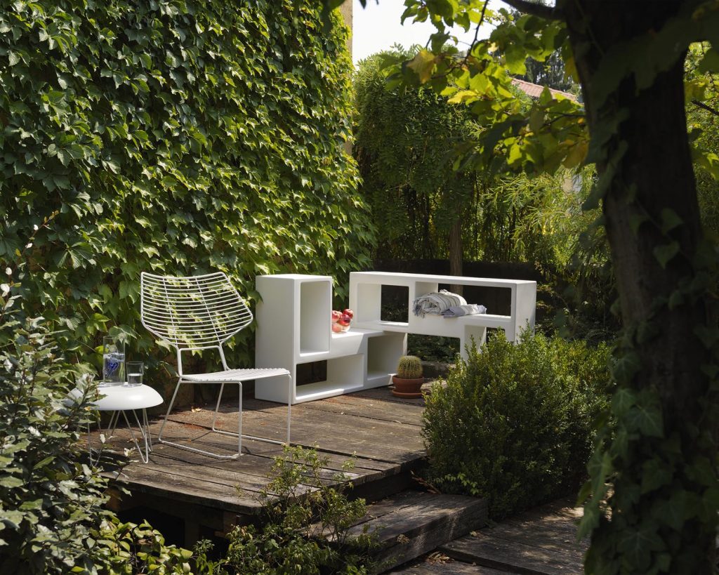 Urban in white color outside on a patio with trees surrounding it