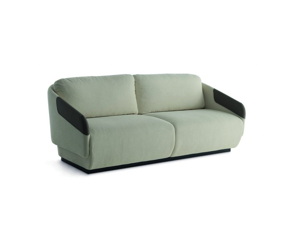 Worn in a couch formation in a mint green color with dark colored armrests in front of a white background