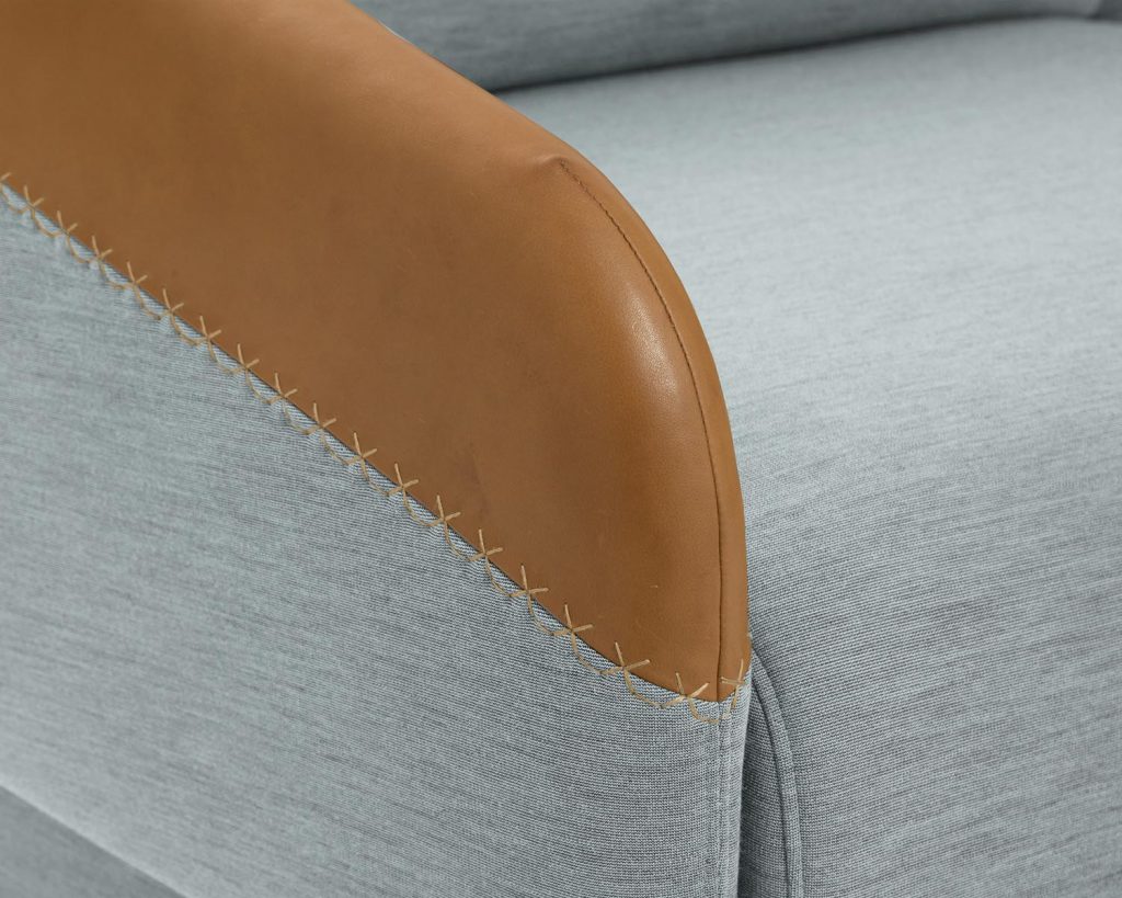 Close-up of Worn chair in grey with brown arm rests