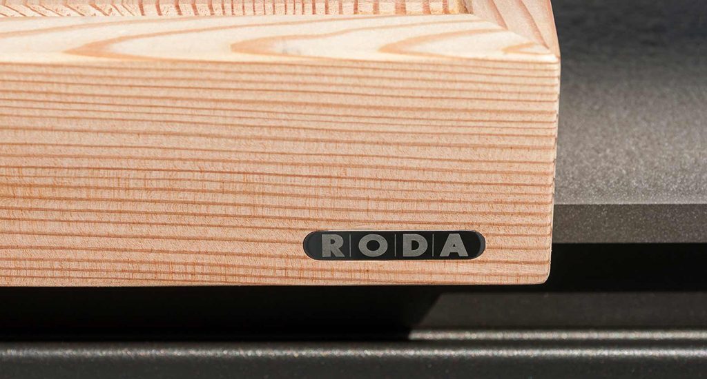 Close up image of the wood side of Norma Two Sink that has RODA written on it in a metal finish