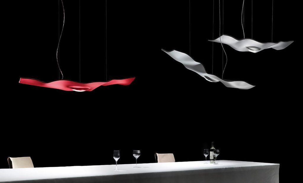 Luce Volante in red, silver, and dark metal in front of a black background