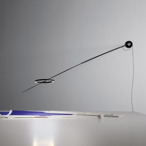 Ringelpiez Wall lamp that is hanging on a wall with a table under it