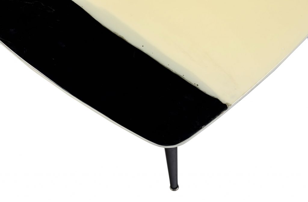 Close up top view of Liquid table with black left edge in front of a white background