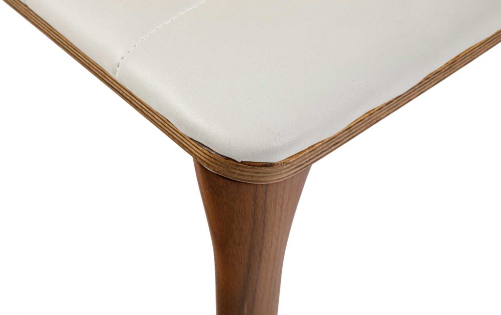 Close up of Pit chair seat corner with leg in frame of white background
