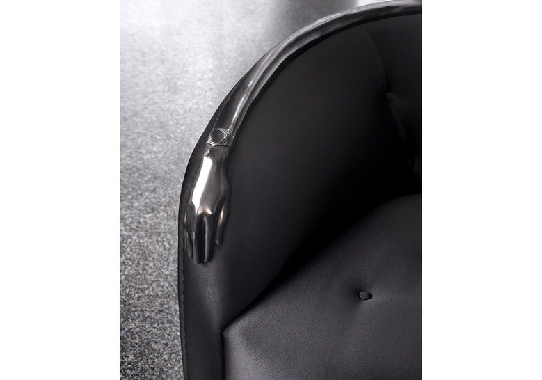 armchair made of black leather and black brass finishes
