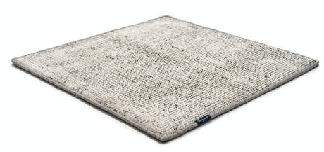 Handmade rug made of fine wool and fabrics in a gray tone on a white background