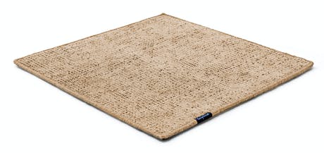 Handmade rug made of fine wool and fabrics in a yellow tone on a white background