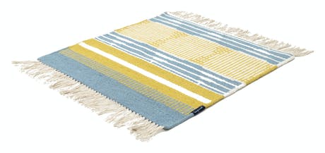 hand-woven rug with fabric in shades of blue yellow and beige