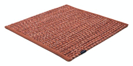 rugs made of hand-woven and braided fabric in a red tone