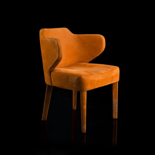 EX Tra Chair upholstered in orange leather and four wood legs on a black background.