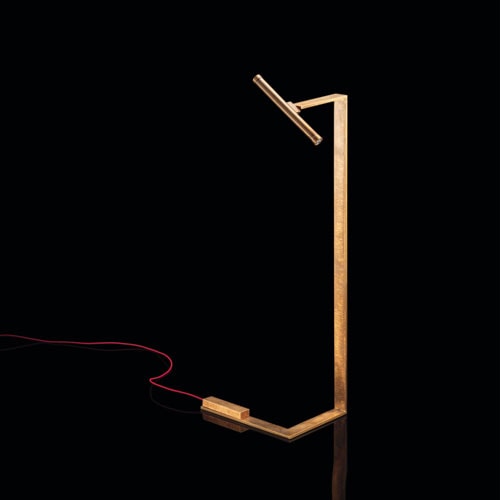 Let Flat Lamps with brass pipe structure, multi directional light, power lead with red silk cover, counterweight in stone on a black background.