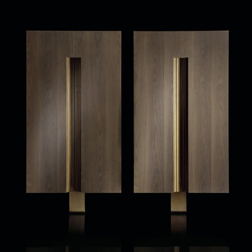 Two rectangular frame Cabinets made of wood with closure and base in brass on a black background.