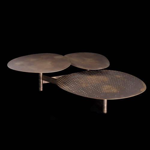 Galaxy table with three round giratory tables made of metal and brass on a black background.