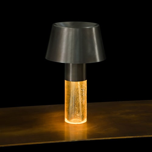 Ghost Lamp Table, central element in resin, light diffuser in steel on a table on a black background.