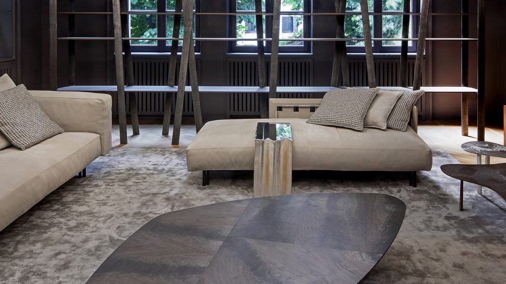 Gibson Coffee Table, top in wood and black steel central leg in a living room.