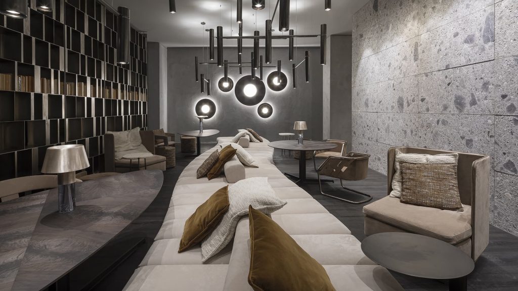 Gibson Coffee Table, top in wood and black steel central leg in a living room.