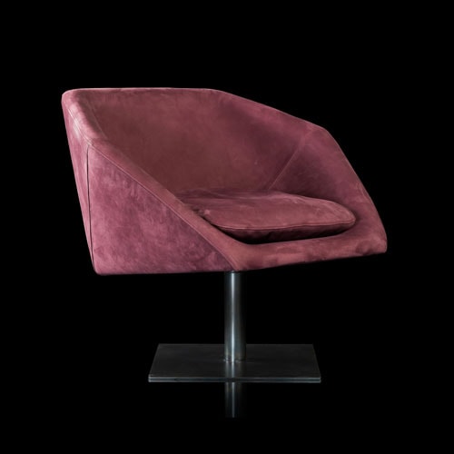 Hexagon Armchair upholstered in pink leather and brass finished central leg on a black background.