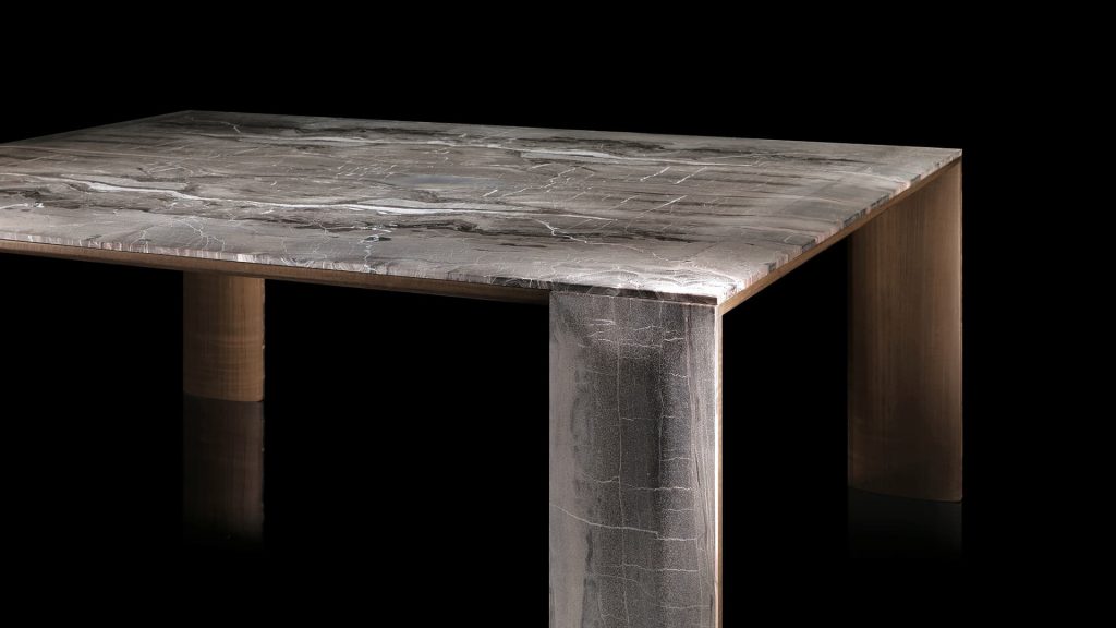 Closeup of rectangle LY Table. four rectangle legs and top in natural wood covered with silver steel on a black background.