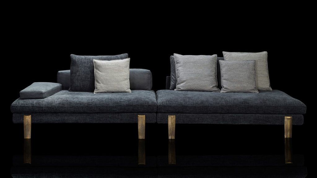 two-piece sofa made of steel base and upholstered in blue textile fabric on a black background