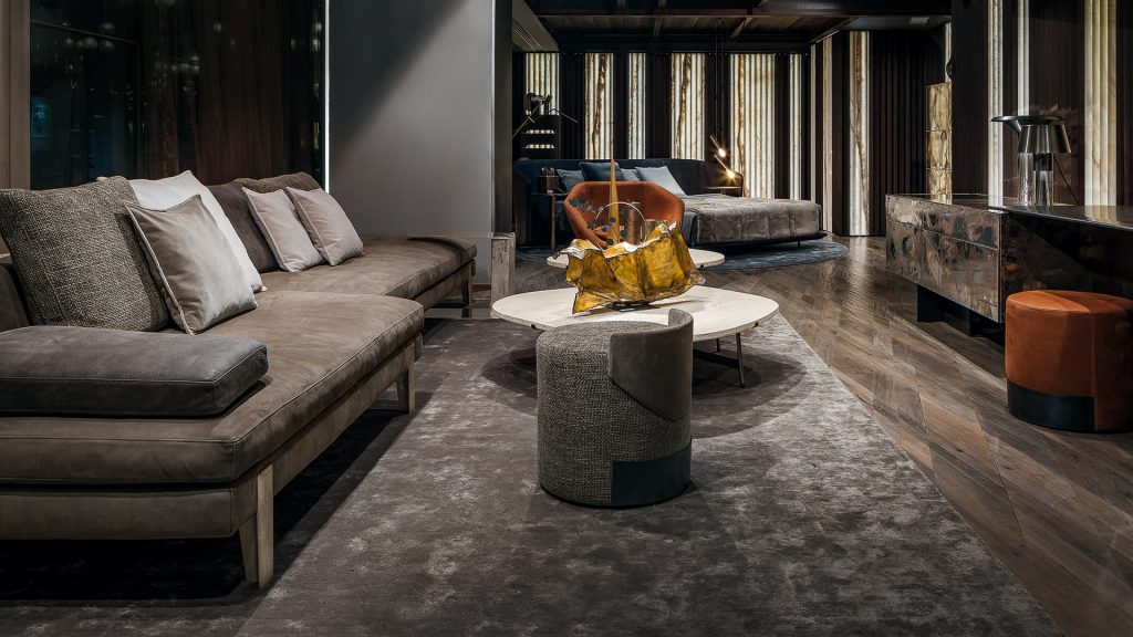 sofa upholstered in velvet fabric in a brown tone and with a base on steel legs