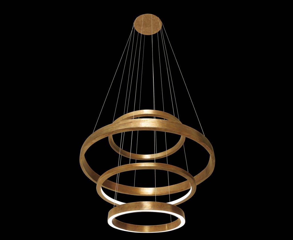 LED Pendant Light Ring made up of four brass rings using suspension wires on a black background.