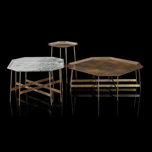 Three Octagon Tables, finish structure and eight legs in burnished brass, two tabletops in brass ans one in white and gray stone on a black background.