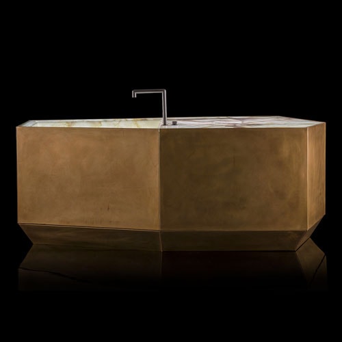 Ozone Evo kitchen bar, cover in brass, top and sink in white and brown irregluar pattern marble stone with black faucet on a black background.