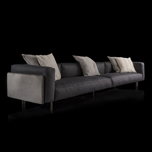 Three seater gray RF Sofa upholstered in fabric with backrest and armrest and nine legs in black wood with five gray cushions on a black background.