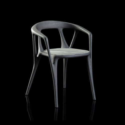 Savanna dining chair in black wood with four legs. Seat covered with black leather on a black background.